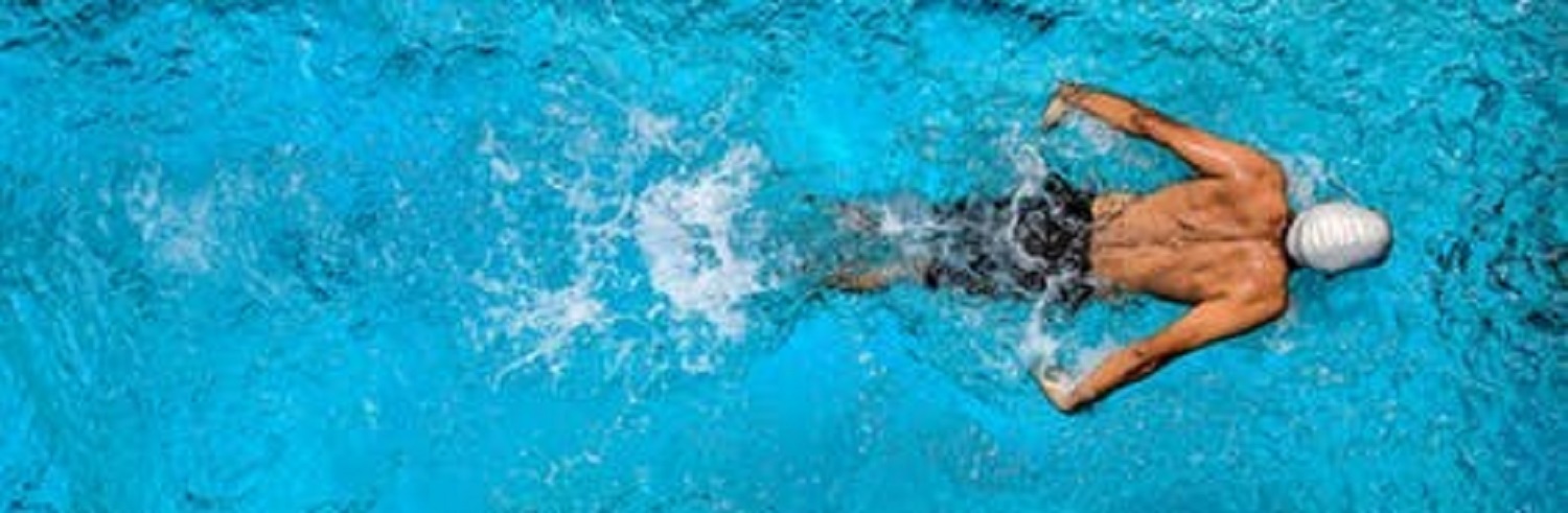 Male competition swimmer going for the finish